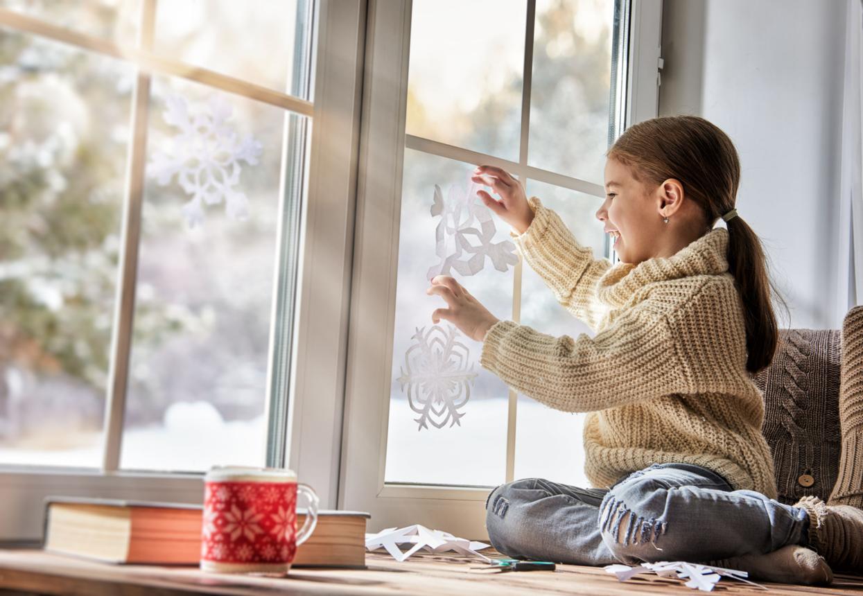 Child makes paper snowflakes