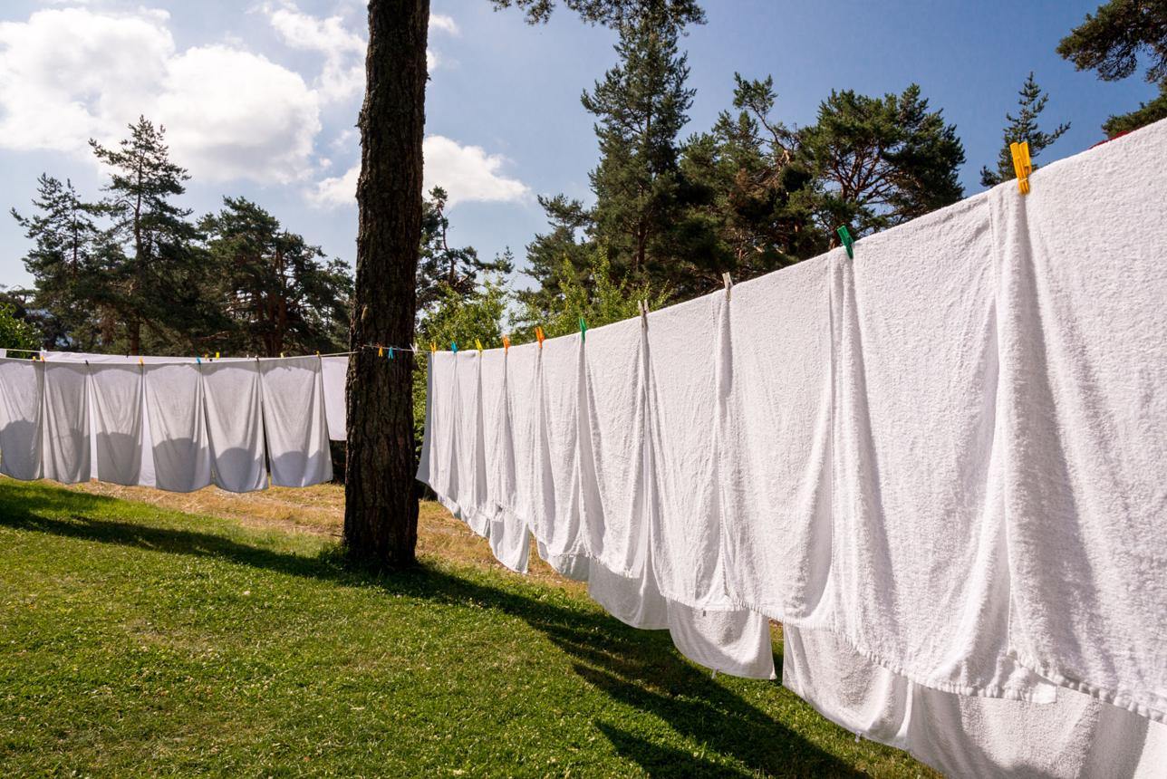fresh clean white towels drying on washing line in outdoor