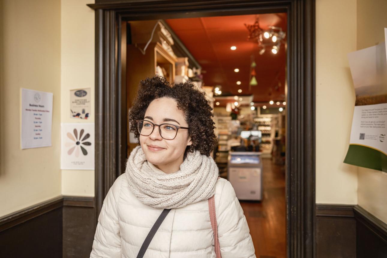 Young Hispanic female leaving local food store